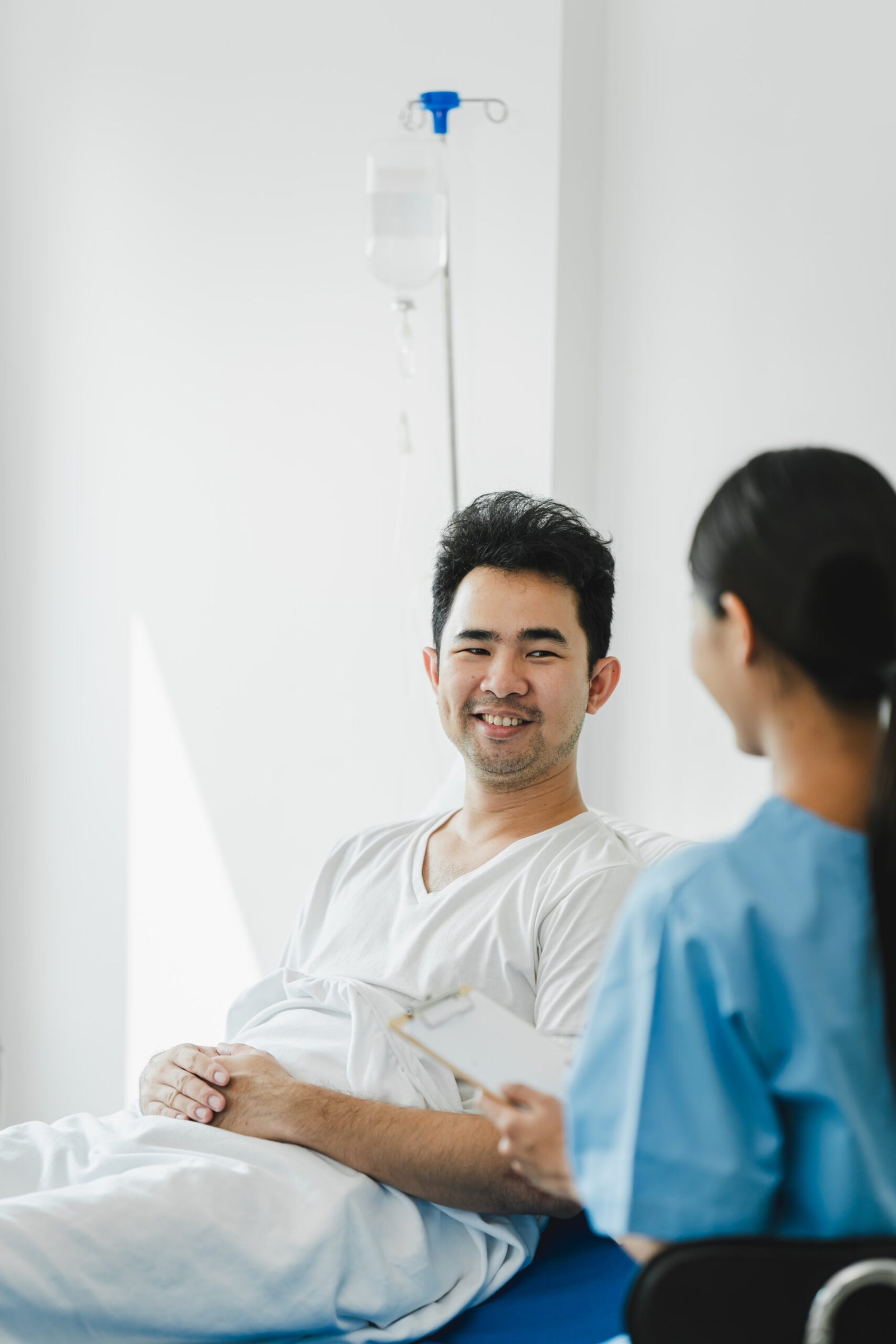 Doctor talking to patient and filling patient history, examinati